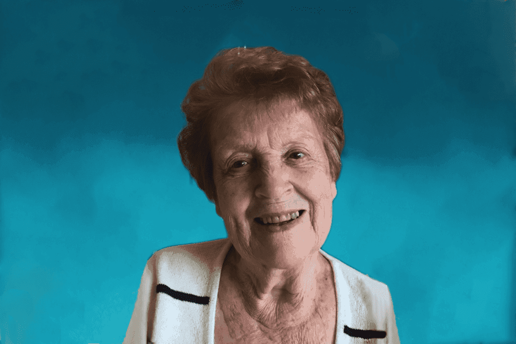 A smiling lady in the blue background